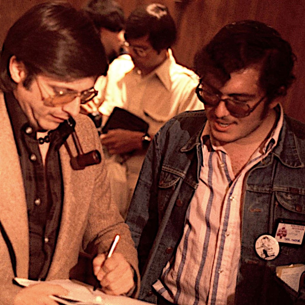 Harlan Ellison signs an autograph for a fan.