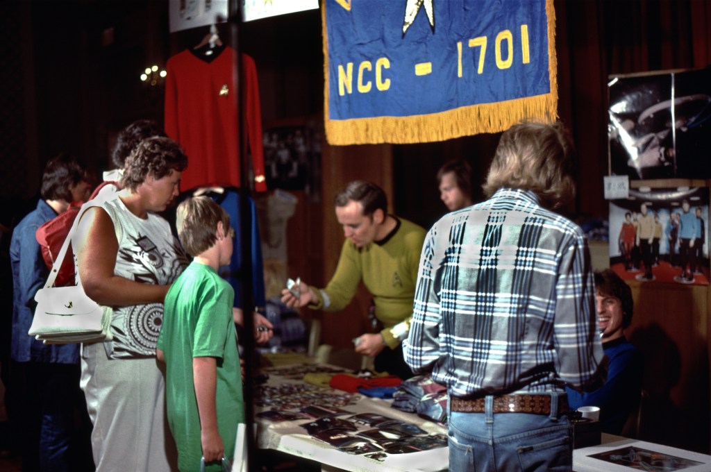 The main dealers' room, with a woman and child checking out a table of collectibles.