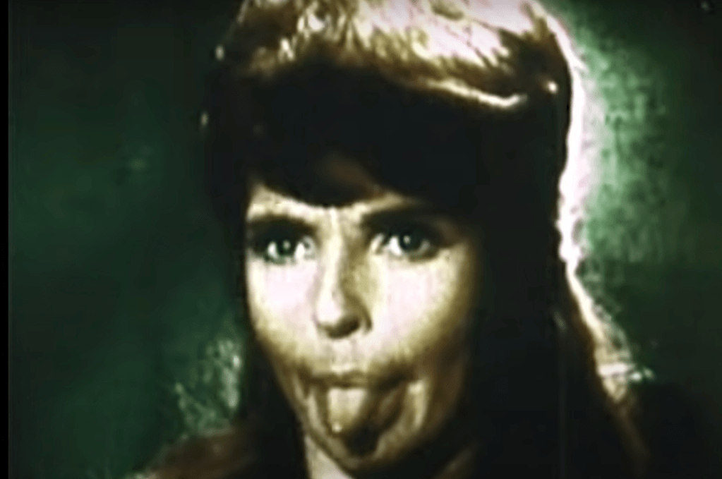 A screencap from the Star Trek bloopers featuring actor Madlyn Rhue sticking out her tongue while filming Space Seed.