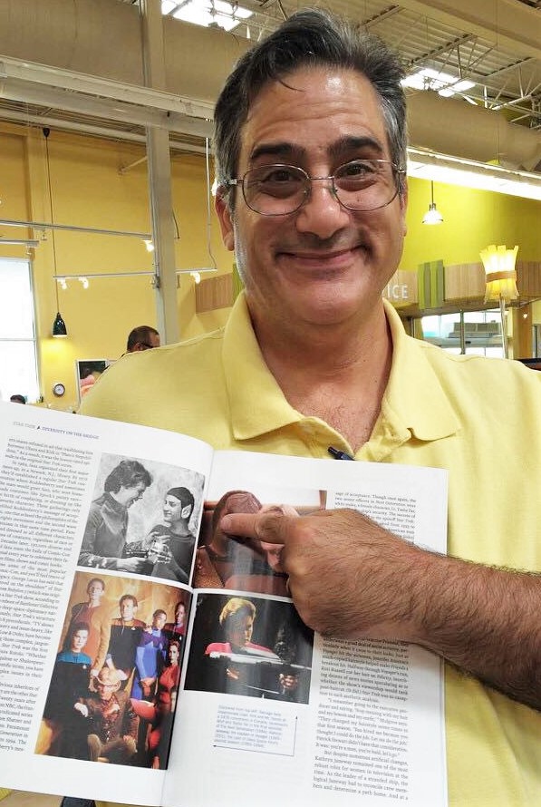 George Hollo points to a photo of himself in Time magazine.