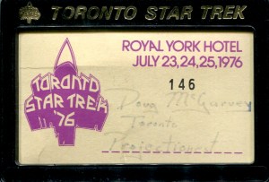 The badges given out to convention organizers, guests, and attendees were black plastic frames with a card bearing the convention logo, dates, and a space for writing the person's name. 