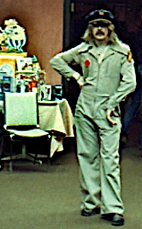 Raymond Alexander, striking a pose in an off-white jumpsuit