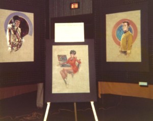 Three prints of paintings by Kelly Freas, showing Spock, Uhura, and Kirk.